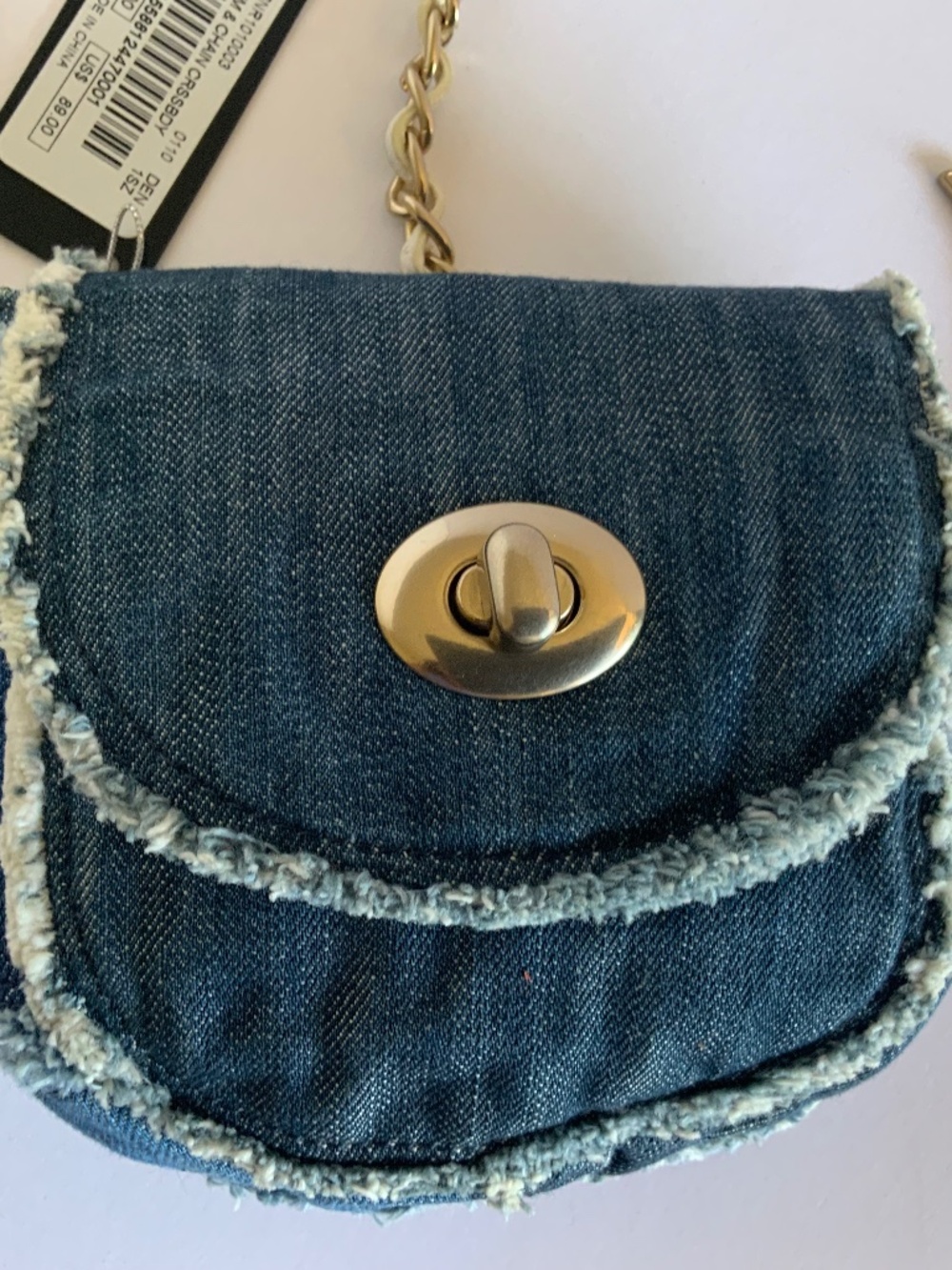 Vintage small blue denim crossbody bag by BEBE with chain strap and charms